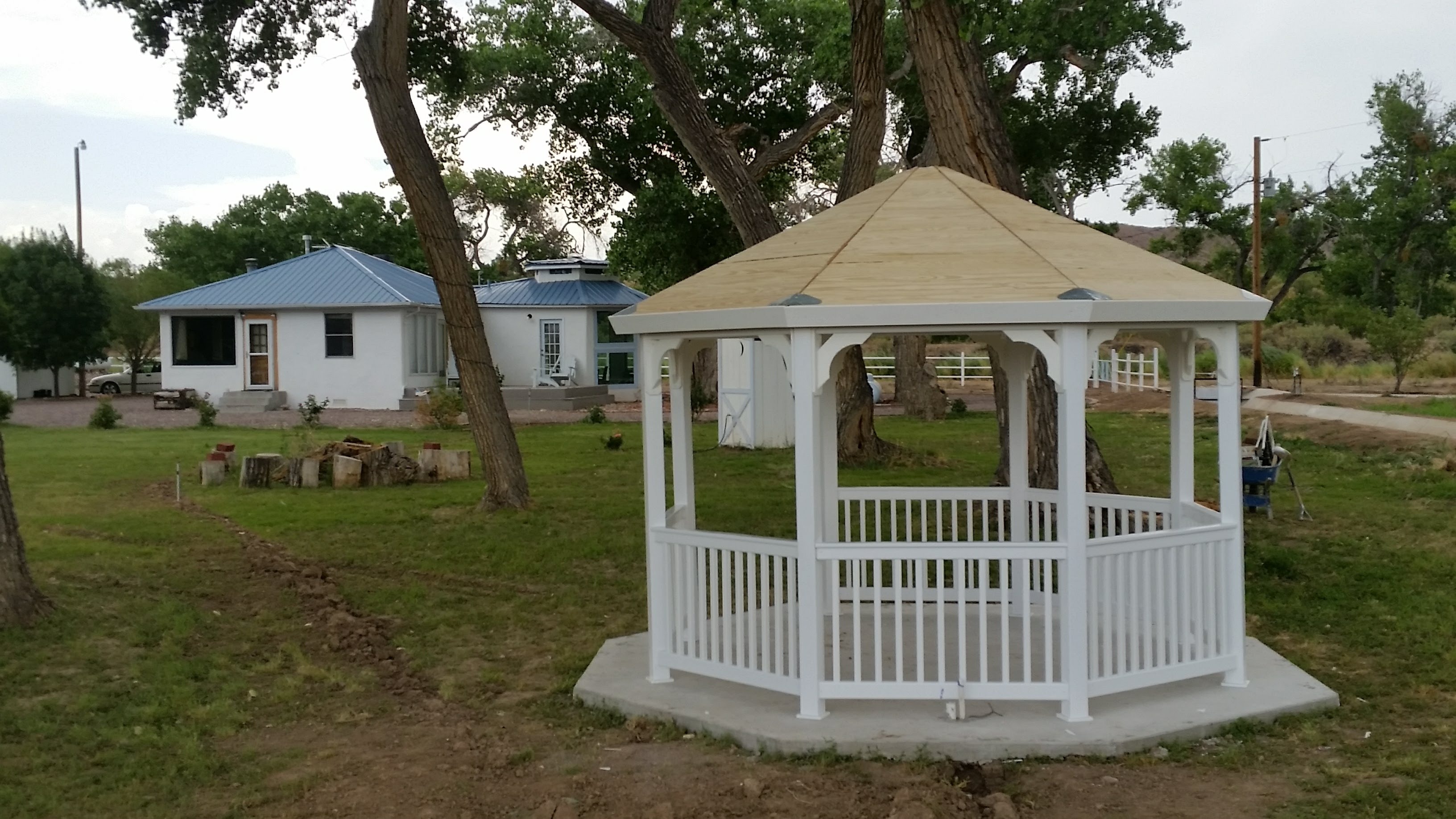Finished white gazebo beside the New Mexico home