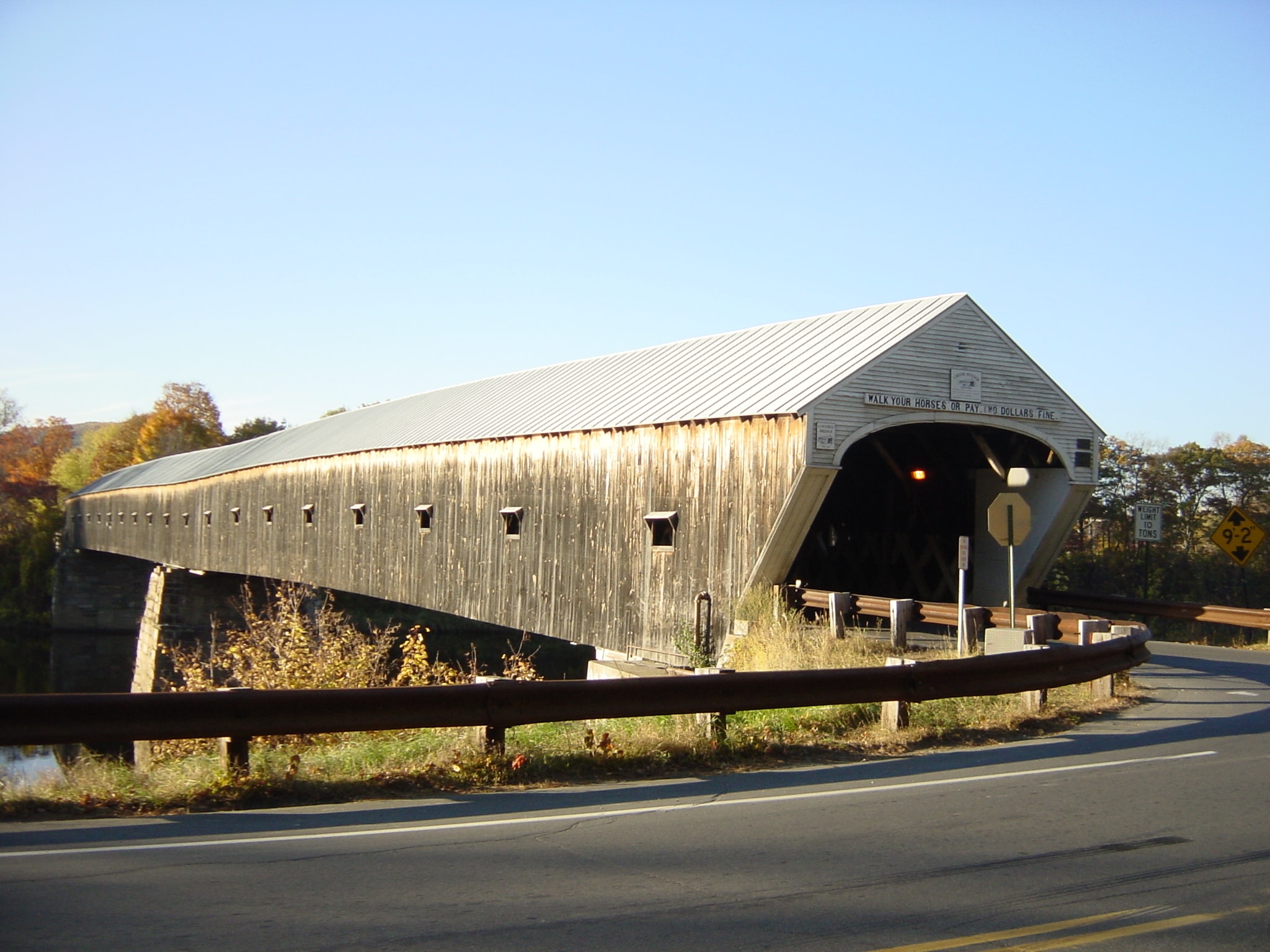 Covered wooden bridge in a Vermont autumn landscape