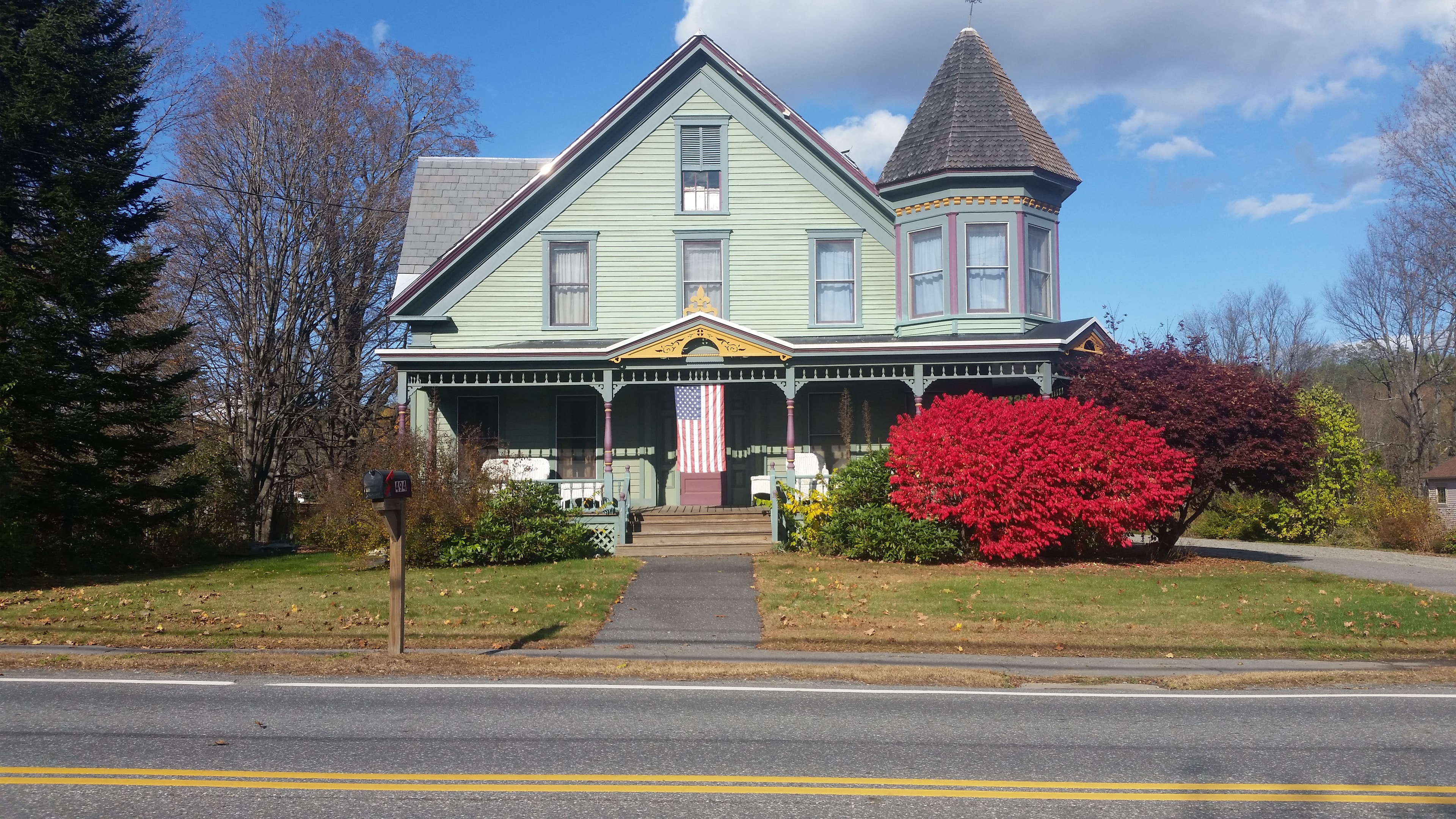 Victorian house with autumn foliage in Vermont