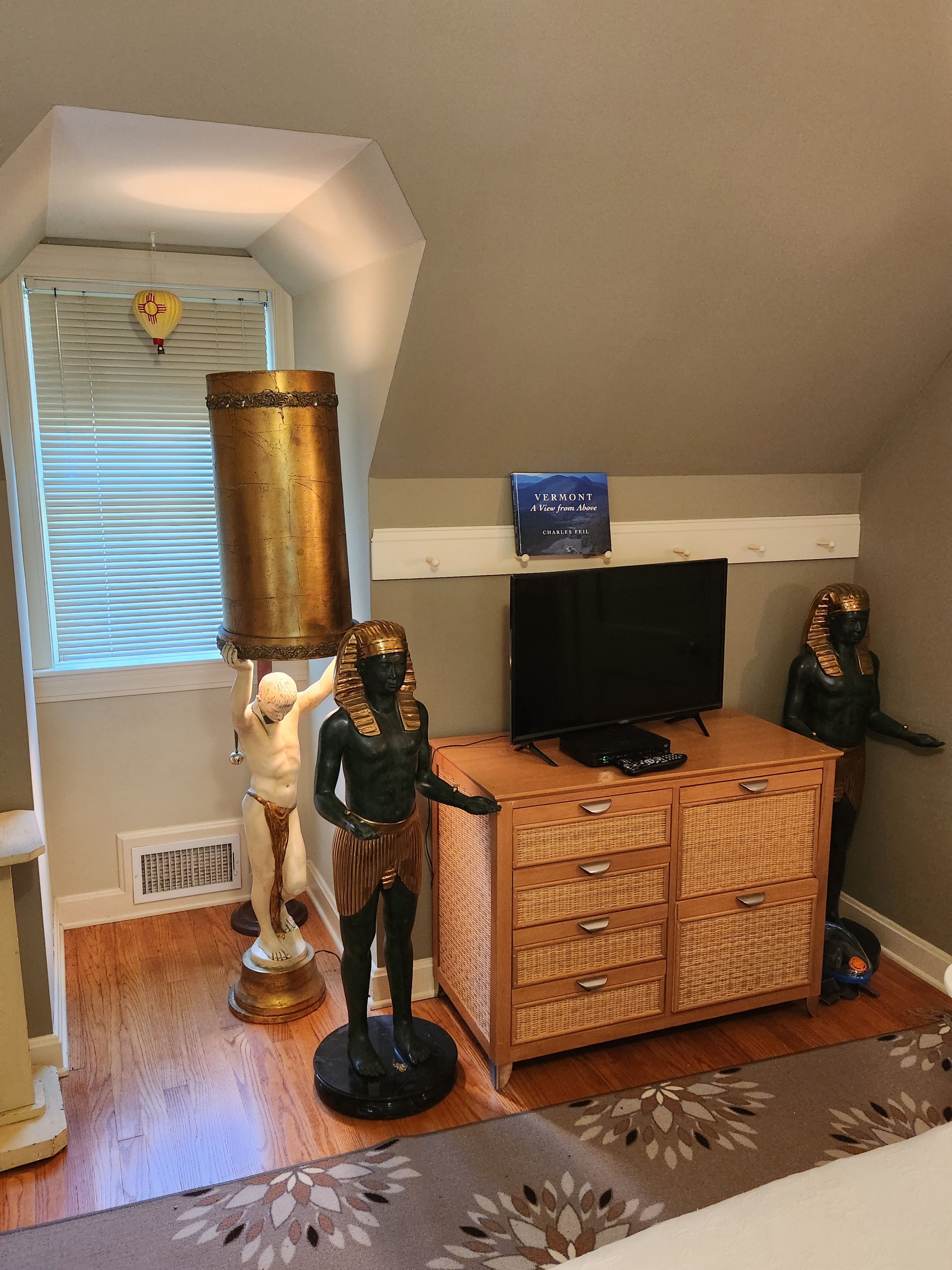 Eclectic living room with Egyptian-style sculptures at 45 Common Street