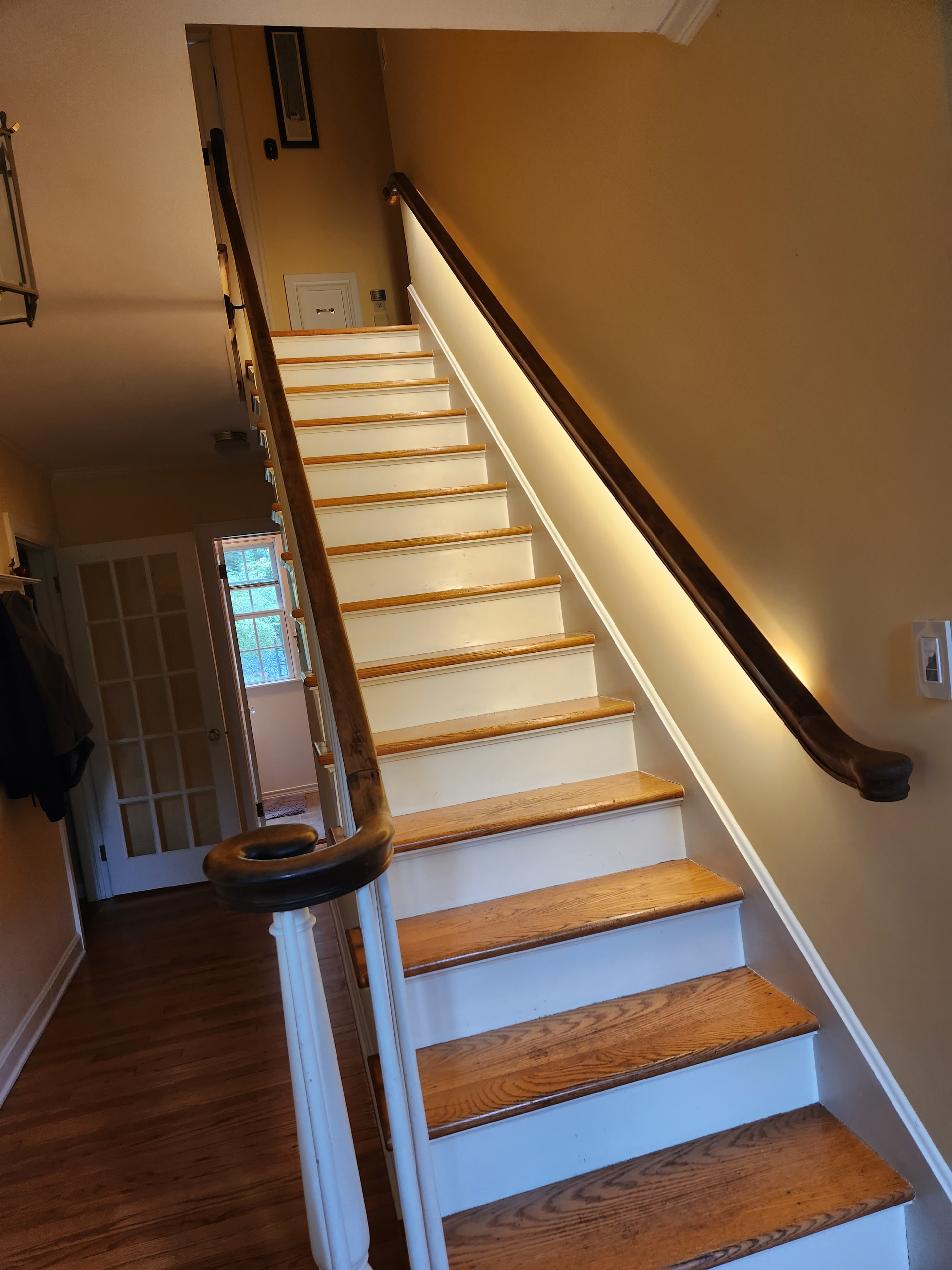Interior staircase with wooden railings and warm lighting